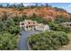 Wonderful home with a terracotta roof, lush surroundings, and a long driveway up to the house providing privacy and curb appeal at 5085 Red Rock Dr, Larkspur, CO 80118