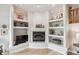 Corner fireplace with gold trim and decorative shelving, perfect for displaying art and decor at 5085 Red Rock Dr, Larkspur, CO 80118