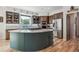Gorgeous kitchen features a stylish center island, stainless steel appliances, hardwood floors, and plenty of cabinet space at 5085 Red Rock Dr, Larkspur, CO 80118