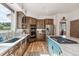 Bright and modern kitchen with a gas cooktop, stainless steel appliances, beautiful hardwood floors, and views of the green outdoors at 5085 Red Rock Dr, Larkspur, CO 80118