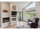 Bright living room with a fireplace, large windows with a view, and modern furnishings at 5085 Red Rock Dr, Larkspur, CO 80118