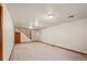 Spacious carpeted basement with stairs to the upper level at 6196 S Rosewood Dr, Littleton, CO 80121