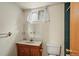 Small bathroom with tiled shower and sink at 6196 S Rosewood Dr, Littleton, CO 80121