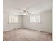 Spacious bedroom with a ceiling fan and two windows that offer abundant natural light at 6196 S Rosewood Dr, Littleton, CO 80121