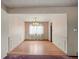 Elegant dining room with hardwood floors, wainscoting, and a chandelier over the table at 6196 S Rosewood Dr, Littleton, CO 80121