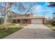 Charming two-story home with an attached garage and well-kept lawn at 6196 S Rosewood Dr, Littleton, CO 80121
