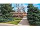 Charming home with a spacious front yard, mature trees, and long driveway at 6196 S Rosewood Dr, Littleton, CO 80121