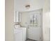 Laundry room featuring washer, dryer, storage cabinets, and door with decorative glass at 6196 S Rosewood Dr, Littleton, CO 80121
