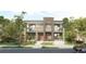 Modern two-story home with a symmetrical facade, small balconies, and professionally landscaped front yard at 2145 High St, Denver, CO 80205