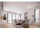 Bright and airy living room features contemporary furnishings, light hardwood floors and large windows with scenic views at 2145 High St, Denver, CO 80205