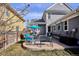 Inviting backyard patio featuring comfortable seating and a vibrant blue umbrella, great for entertaining and enjoying the outdoors at 2321 Alton St, Denver, CO 80238