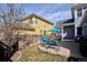 Cozy backyard patio with stylish furniture, perfect for outdoor dining and relaxation, with decorative string lights and privacy fence at 2321 Alton St, Denver, CO 80238