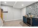 Basement bar area with sleek bar fridge, creating a cozy and inviting space for relaxation and entertainment at 2321 Alton St, Denver, CO 80238