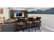 Basement entertainment area with bar stools and a table looking out onto a relaxing seating area at 2321 Alton St, Denver, CO 80238