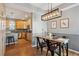 Dining room and kitchen combo with black chairs, a wooden table and stainless steel appliances at 2321 Alton St, Denver, CO 80238