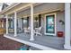 Inviting front porch featuring a porch swing, Adirondack chairs, and stylish decor at 2321 Alton St, Denver, CO 80238