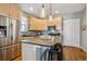 Modern kitchen with stainless steel appliances, sleek countertops, and a functional island at 2321 Alton St, Denver, CO 80238