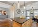 Kitchen featuring light wood cabinets, granite countertops, and a view into the living room at 2321 Alton St, Denver, CO 80238