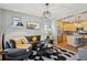 Open-concept living room flowing into the kitchen with hardwood floors and modern decor at 2321 Alton St, Denver, CO 80238