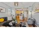 Open-concept living room flowing into the kitchen with hardwood floors and modern decor at 2321 Alton St, Denver, CO 80238