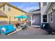 Backyard patio area with outdoor seating and a blue umbrella for shade and protection from the elements at 2321 Alton St, Denver, CO 80238