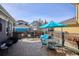 Backyard patio area with outdoor seating and a vibrant blue umbrella for shade at 2321 Alton St, Denver, CO 80238