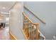 Carpeted stairs with wooden railing and trim, creating a warm and inviting transition between floors at 2321 Alton St, Denver, CO 80238