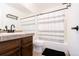 Bathroom featuring a wood vanity, modern fixtures, and a shower with a striped curtain at 1111 Maxwell Ave # 233, Boulder, CO 80304