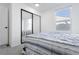 Bright bedroom featuring neutral carpet and blue and white comforter with mirrored closet at 1111 Maxwell Ave # 233, Boulder, CO 80304