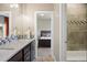 En-suite bathroom featuring double sinks, a shower and a view into the bedroom at 1803 Avenida Del Sol, Castle Rock, CO 80104