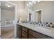 Bathroom with double sinks, modern vanity, and tile accents, leading into a Bedroom at 1803 Avenida Del Sol, Castle Rock, CO 80104
