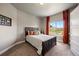 Cozy bedroom features a full-sized bed with orange curtains and a window with a nice view at 1803 Avenida Del Sol, Castle Rock, CO 80104