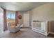 This cozy Bedroom features a crib, rocking chair, and a natural view at 1803 Avenida Del Sol, Castle Rock, CO 80104