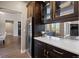 The butler's pantry features dark wood cabinetry, wine cooler, and marble countertops, providing elegance and functionality at 1803 Avenida Del Sol, Castle Rock, CO 80104