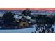 View of snow covered home with mountain views at sunset at 1803 Avenida Del Sol, Castle Rock, CO 80104