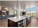 Open kitchen with center island, stainless appliances, pendant lights and hardwood floors at 1803 Avenida Del Sol, Castle Rock, CO 80104