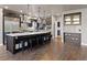 Modern kitchen features a large island, dark wood cabinets, and hardwood floors at 1803 Avenida Del Sol, Castle Rock, CO 80104