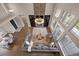 Open-concept living room featuring a stone fireplace, custom lighting, and large windows at 1803 Avenida Del Sol, Castle Rock, CO 80104
