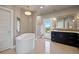 Elegant bathroom featuring a soaking tub, walk-in shower, and dark wood cabinets offering spa-like tranquility at 1803 Avenida Del Sol, Castle Rock, CO 80104
