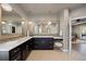 The bathroom offers a makeup vanity, dual sinks, decorative mirrors, and modern fixtures for a comfortable experience at 1803 Avenida Del Sol, Castle Rock, CO 80104