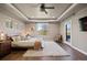 An inviting main bedroom with a cozy rug, tray ceiling, and access to a private balcony at 1803 Avenida Del Sol, Castle Rock, CO 80104