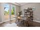 Bright home office with a large desk, built-in shelves, and French doors leading to a balcony at 1803 Avenida Del Sol, Castle Rock, CO 80104