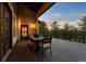 Covered deck featuring an outdoor dining area with seating and scenic treetop views at 1803 Avenida Del Sol, Castle Rock, CO 80104