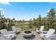 Outdoor entertaining deck with Adirondack chairs surrounding a modern fire pit, perfect for relaxing at 1803 Avenida Del Sol, Castle Rock, CO 80104