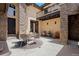Inviting outdoor patio with elegant seating, stone accents, and tranquil fountain, perfect for entertaining at 1803 Avenida Del Sol, Castle Rock, CO 80104