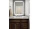 Modern powder room featuring a custom mirror and a sleek quartz countertop at 1803 Avenida Del Sol, Castle Rock, CO 80104