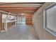 Unfinished basement featuring exposed ceilings, concrete walls, and a window at 6417 S Florence Way, Englewood, CO 80111