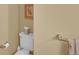 Bathroom view showcasing toilet, towel rack, and decorative elements at 6417 S Florence Way, Englewood, CO 80111