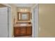 Bathroom featuring a wood vanity, large mirror and neutral walls at 6417 S Florence Way, Englewood, CO 80111