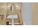 Bathroom features a vintage sink, vanity lighting, and decorative shower curtain at 6417 S Florence Way, Englewood, CO 80111
